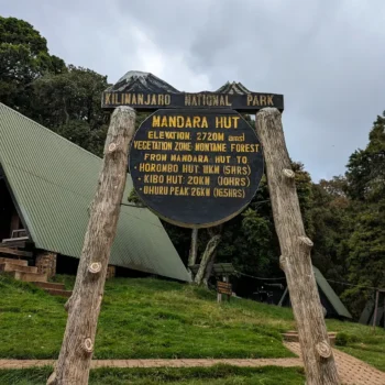 a sign on a wooden post