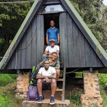 a group of men sitting on stairs in a cabin