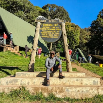a man sitting on a sign