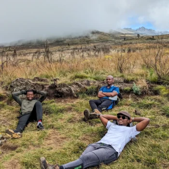 a group of men lying on grass