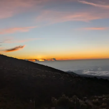 a sunset over a mountain